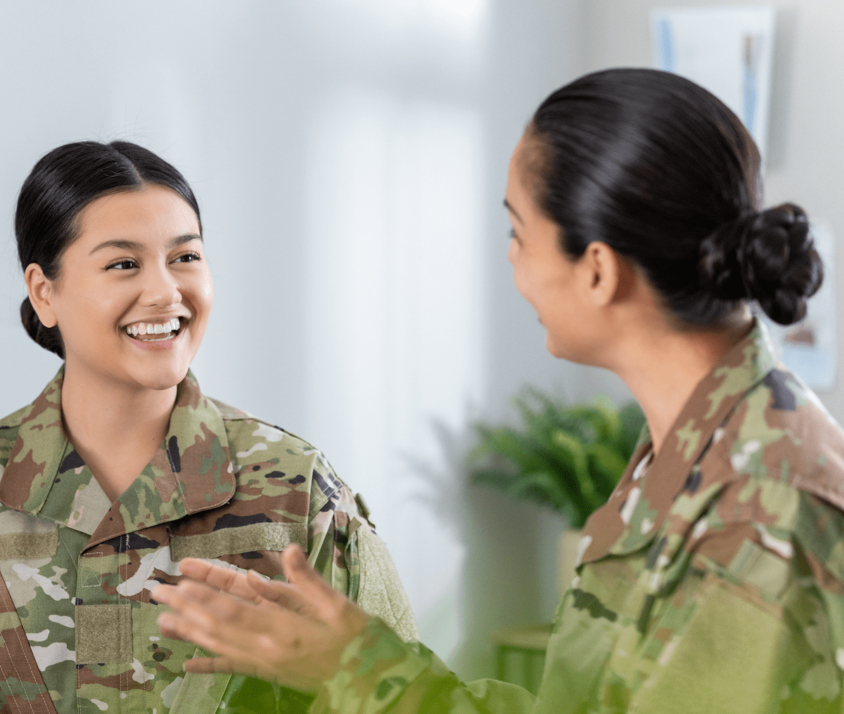Two soldiers smiling and talking