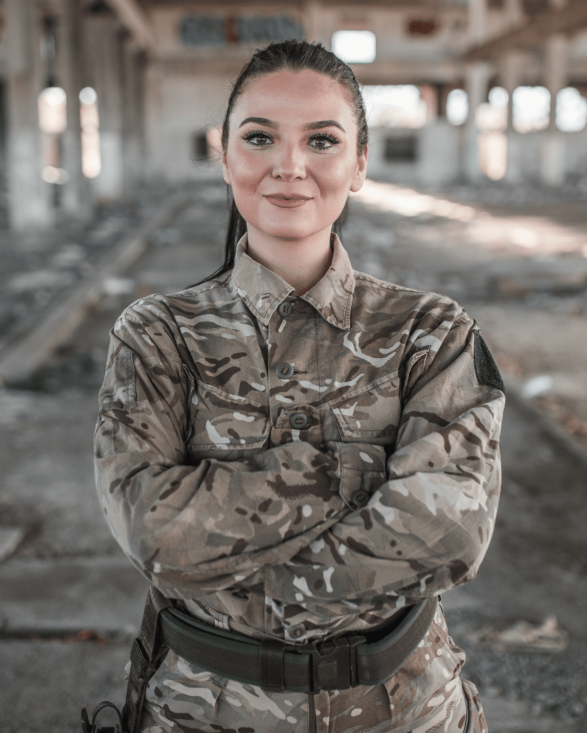 Military woman standing in abandoned structure